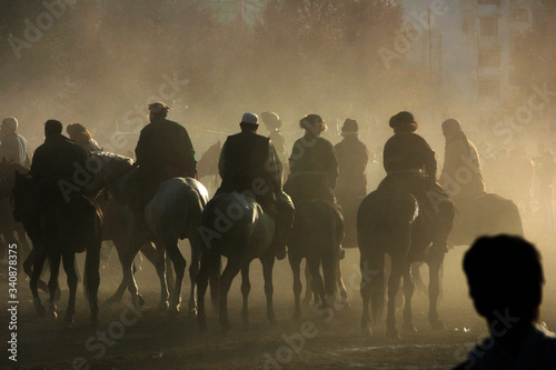 Boskachi horse riders in dust cloud © Vincent