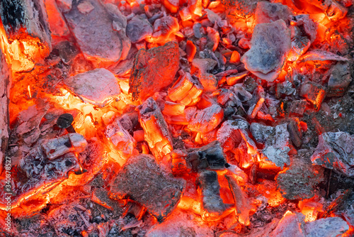 Smoldering charcoal in a bonfire, background texture