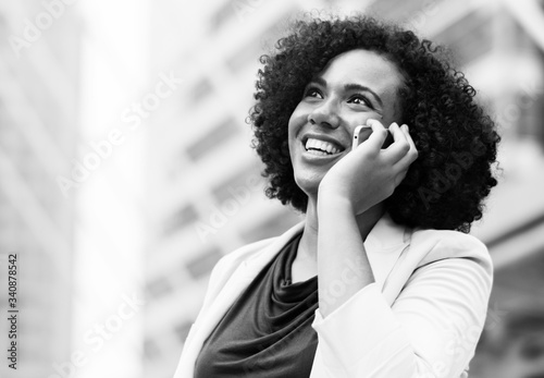 Happy businesswoman talking on the phone