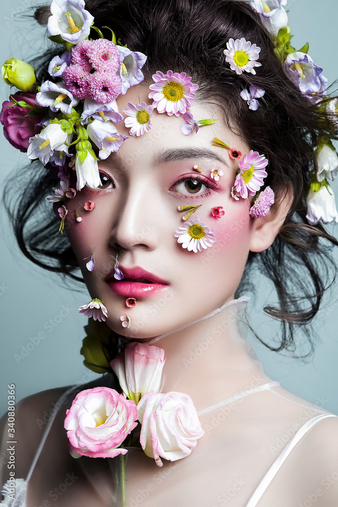 Asian girls decorate their faces with flowers