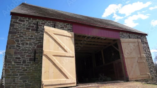 An eighteenth century barn with its doors open.