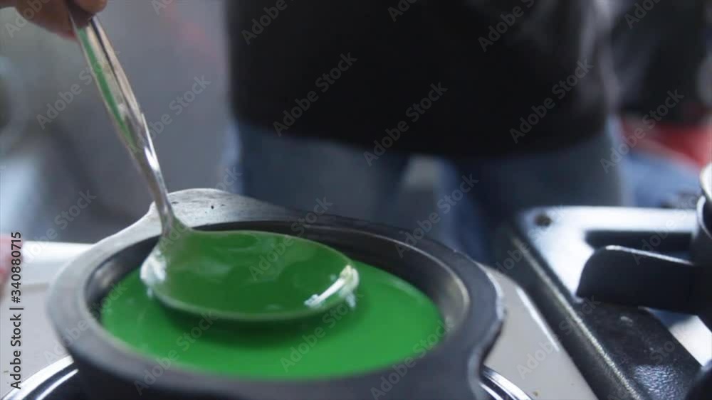 Pouring Green Pandan Batter into a Hot Pancake Stove Slow Motion Pouring Green Pandan Batter into a Hot Pancake Stove Slow Motion