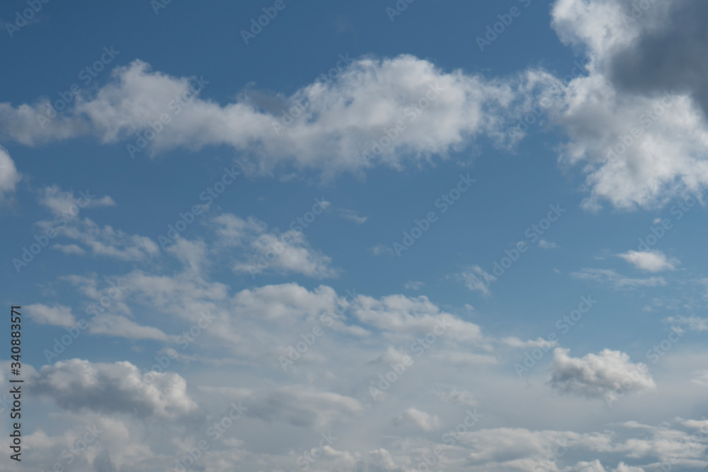 White clouds on a blue background.