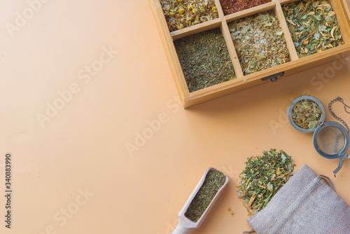 herbs with wooden spoon in brown background