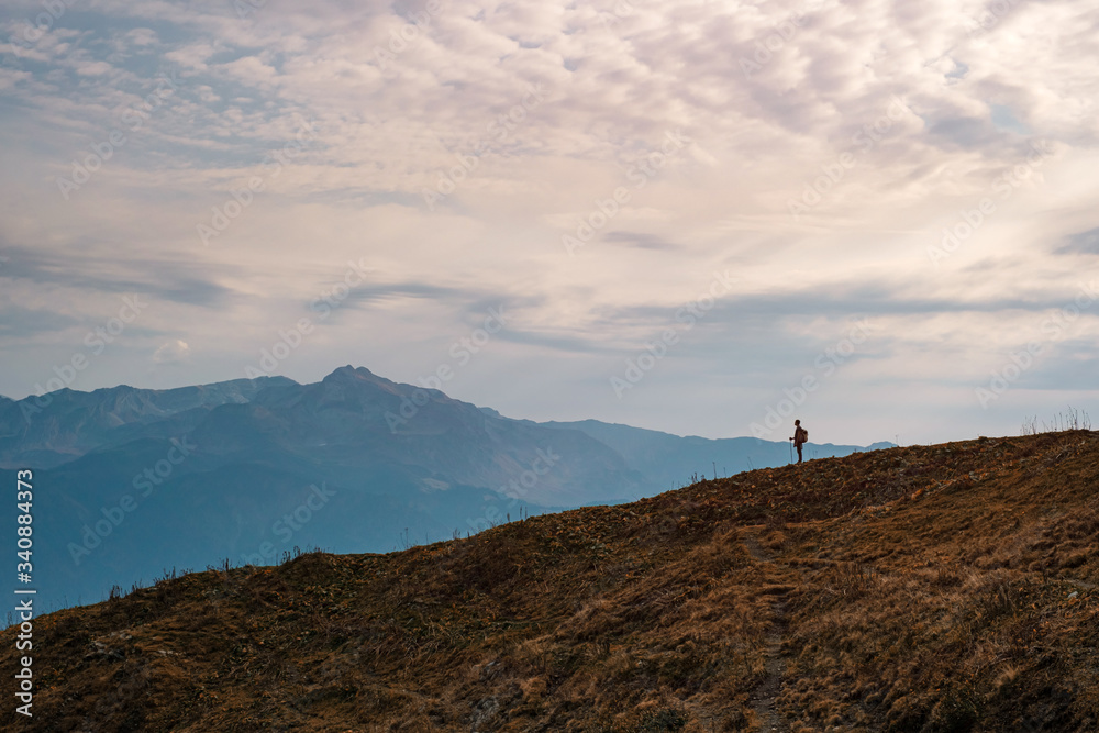 Young male hipster in the mountains in autumn Young male hipster in the mountains in autumn