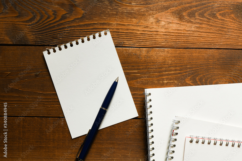 Blank notepad and on office wooden table Blank notepad and on office wooden table