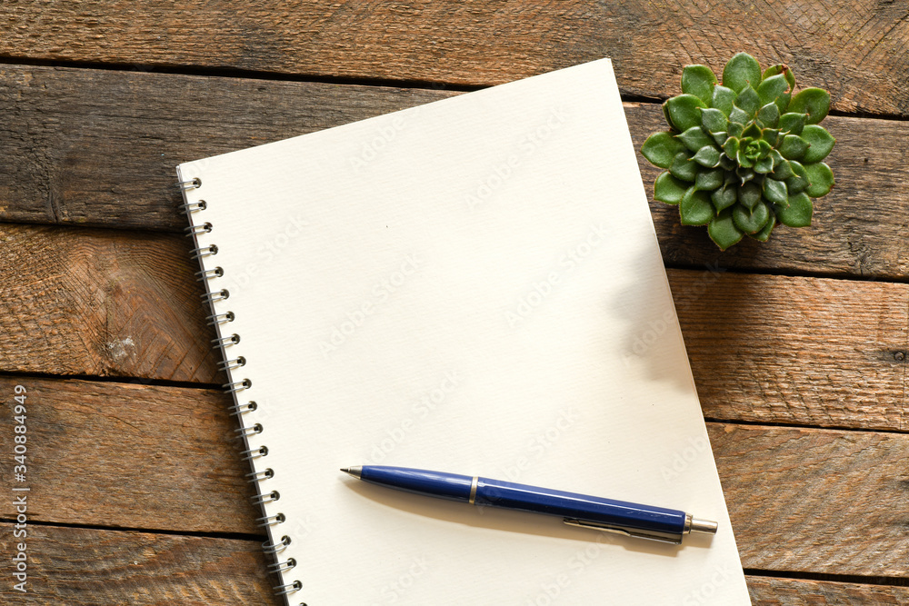 Blank notepad and on office wooden table Blank notepad and on office wooden table