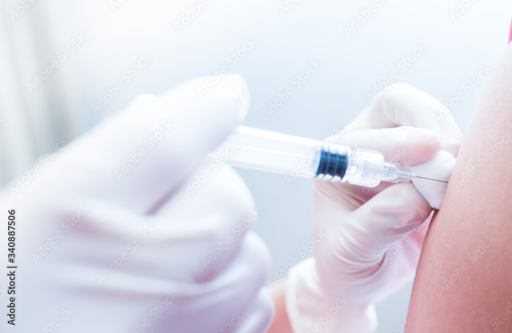 Doctor or nurses hand are adult vaccination to patient using the syringe injected upper arm for treated,Doctor giving an injection to a patient,Prophylactic HPV vaccin, flu, covid-19 and anal cancer. Doctor or nurses hand are adult vaccination to patient using the syringe injected upper arm for treated,Doctor giving an injection to a patient,Prophylactic HPV vaccin, flu, covid-19 and anal cancer.