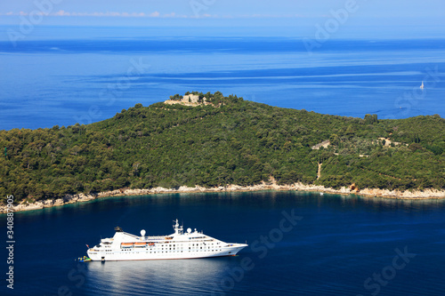 Recreational sailboat and yacht moored beside touristic Lokrum island close to Dubrovnik's Old Town harbour in Dalmatian coast of Croatia. The Adriatic sea deep blue complete this summer panorama.