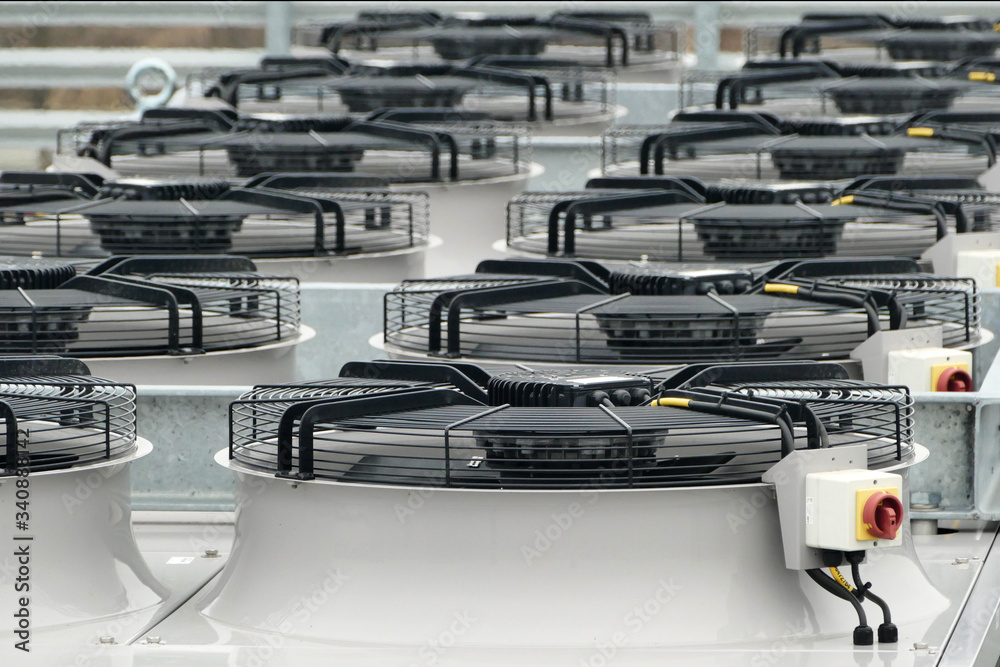 Row of large industrial fans on condenser of ammonia NH3 or Co2 refrigeration system used for cooling chillers and freezers