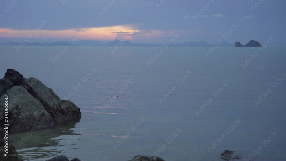 View on the sea and islands from the beach at sunset in summer View on the sea and islands from the beach at sunset in summer