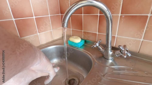 Man disinfects hands with soap and water during the Covid-19 epidemic