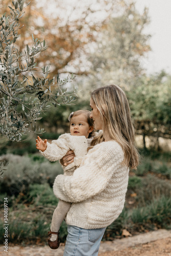 Mother and daughter standing in park