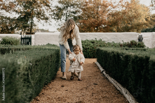Mother and daughter walking in park