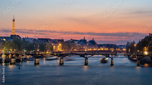 Pedestrian bridge  Pont des Arts  over Seine river and historic buildings of Paris France