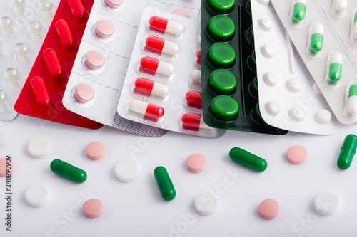 Colorful of tablets and capsules pill in blister packaging. Pharmaceutical industry concept. Pharmacy drugstore. Antibiotic drug resistance.