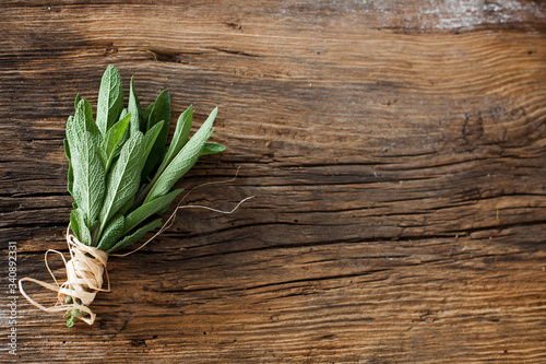 Obraz na płótnie sage- bunch applies herbs on a wooden table - background w salonie