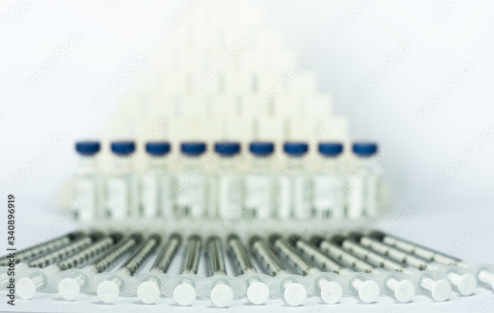 Sugar addiction, insulin resistance, unhealthy diet, sugar cubes pyramid, bottles of insulin and syringe for vaccination on white background, diabetes protection medical concept. Sugar addiction, insulin resistance, unhealthy diet, sugar cubes pyramid, bottles of insulin and syringe for vaccination on white background, diabetes protection medical concept.
