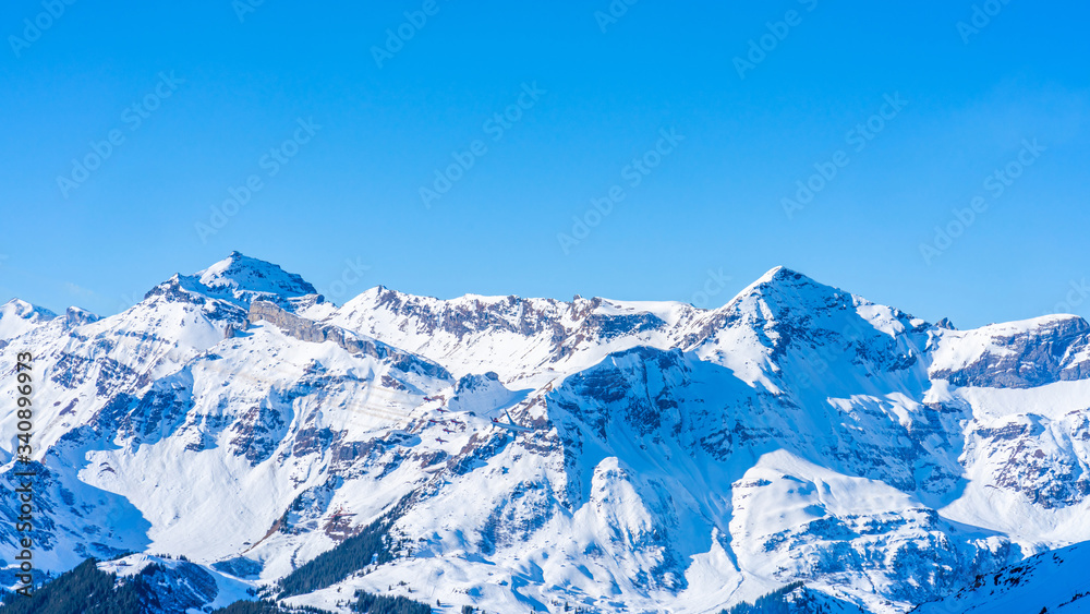 Winter landscape with snow covered peaks on Kleine Scheidegg mountain in Swiss Alps near Grindelwald, Switzerland