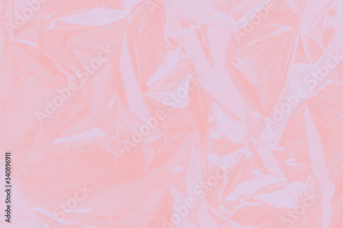 Scrunched up light pink aluminium foil texture. Blurred soft background. Backdrop for wedding  date  romantic invitation and cards.