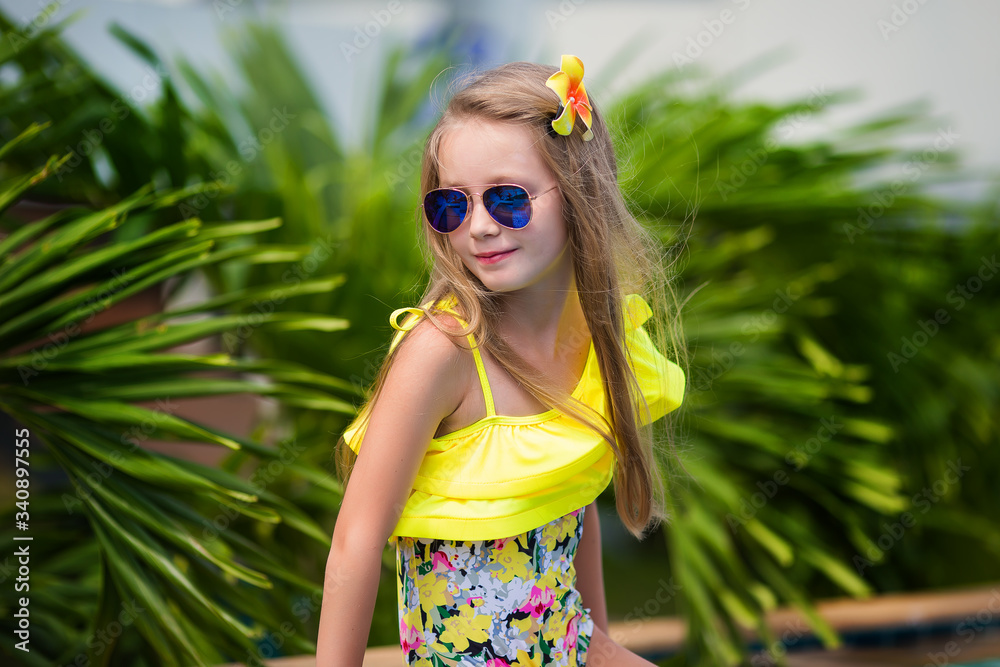 Cute girl in sunglasses in the swimming pool outdoors Cute girl in sunglasses in the swimming pool outdoors