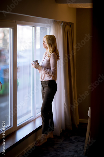 Young woman with cup of tea...