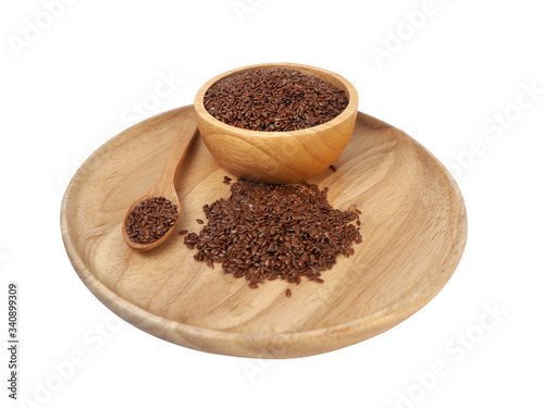 Flax seed placed in a wooden tray  wooden spoon  wooden cup on a white background