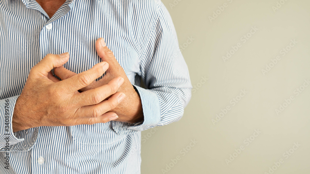 Heart attack problems. Senior man suffering from severe chest pain. Warning signs of unstable angina or myocardrial infarction disease. Health care and cardiological concept. Close up. Copy space.