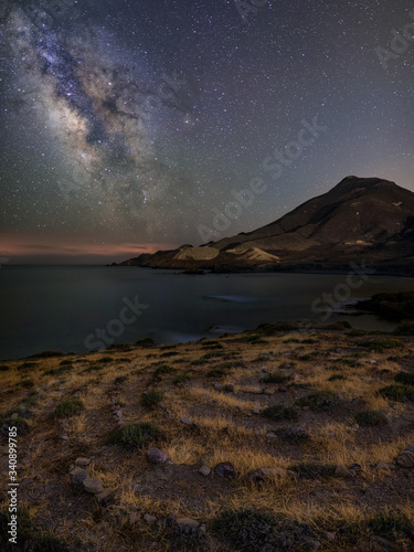 Night landscape of the Almería coast with the Milky Way, on the beach of Los Escullos, in the Cabo de Gata Natural Park. © OszO