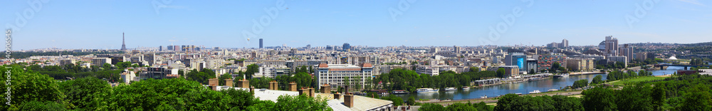 Fototapeta Paris, France - August 26, 2019: Paris from above showcasing the capital city's rooftops, the Eiffel Tower, Paris tree-lined avenues with their haussmannian buildings and Montparnasse tower. 16th