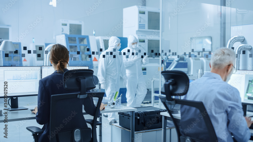 In Clean Workshop: Professional Workers in Coveralls and Masks Use Laptop and Talk. Inside Factory Office: Female Electronics Engineer Works on Computer, Screen Shows Printed Circuit Board 3D Design In Clean Workshop: Professional Workers in Coveralls and Masks Use Laptop and Talk. Inside Factory Office: Female Electronics Engineer Works on Computer, Screen Shows Printed Circuit Board 3D Design