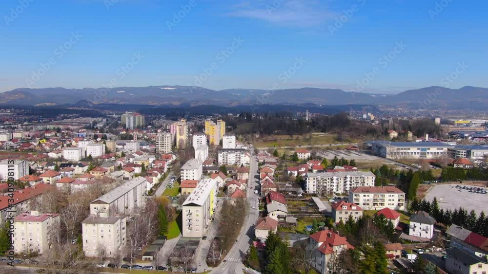 Aerial: Dolly in flight over Celje City in Slovenia with urban landscape with lots of block of flats and houses during a sunny day Aerial: Dolly in flight over Celje City in Slovenia with urban landscape with lots of block of flats and houses during a sunny day