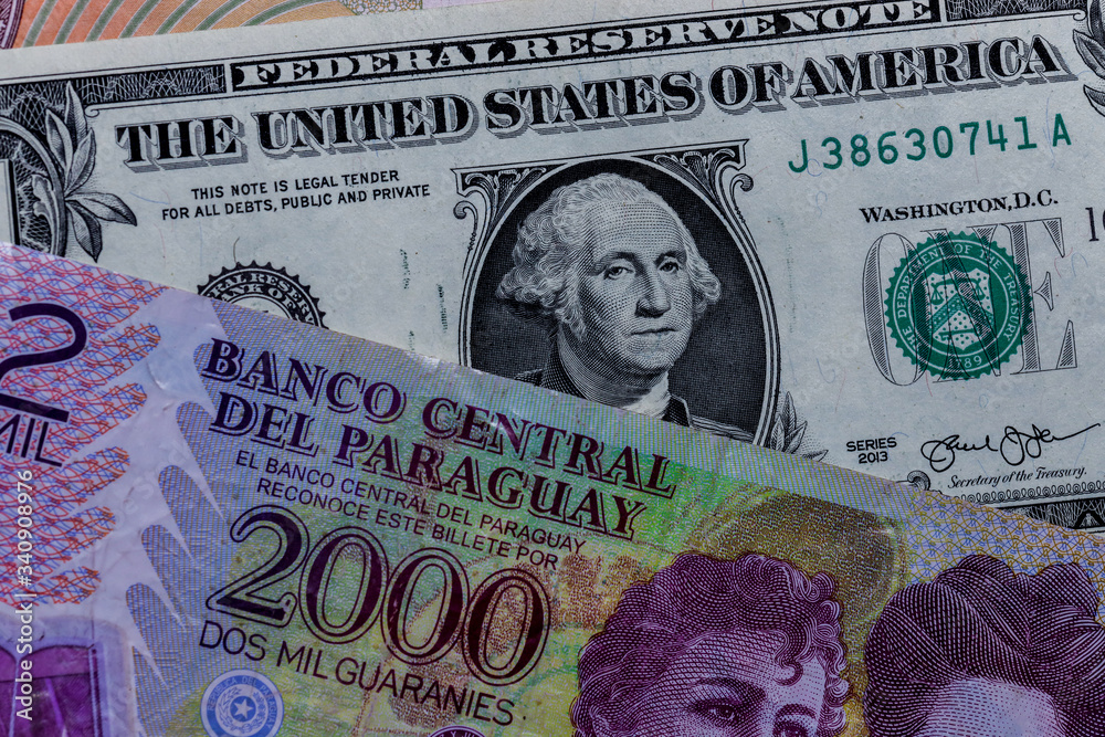 One US Dollar with Different Paraguayan guarani Banknotes Photos