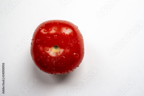 Red tomato on a white background, top view