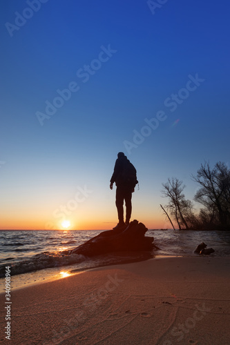 a man looks at the sunset / background photo wilderness landscape