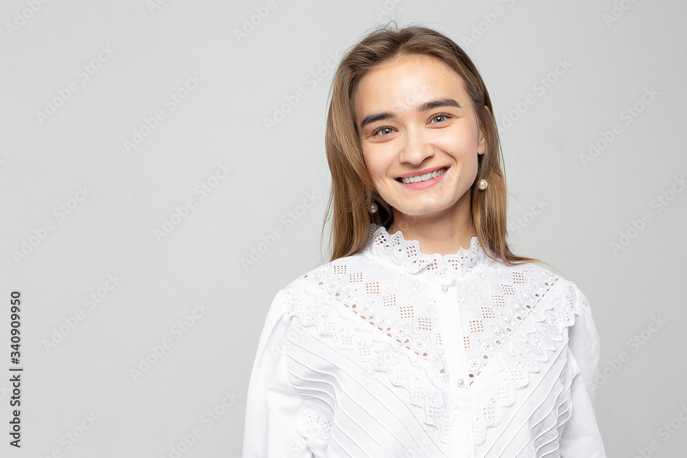 Beautiful young woman portrait. Studio shot, isolated on gray background Beautiful young woman portrait. Studio shot, isolated on gray background