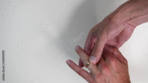 Man puts a wedding ring on his finger. Close up