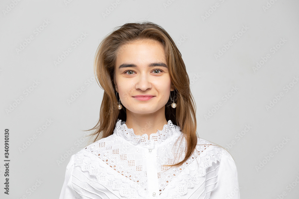 Beautiful young woman portrait. Studio shot, isolated on gray background Beautiful young woman portrait. Studio shot, isolated on gray background