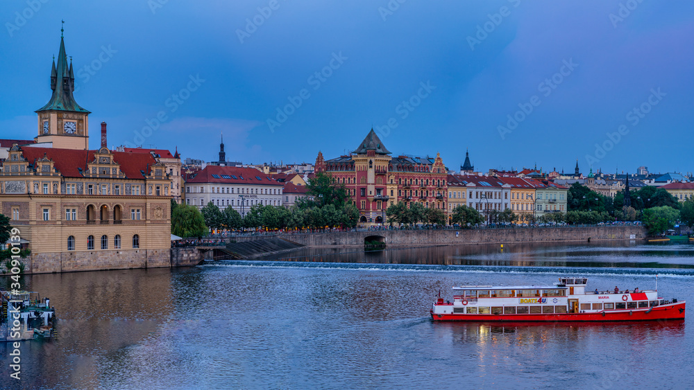 View on Old Town, tourist boat and Vltava river embankment, Prague, Czech Republic. Prague city center.