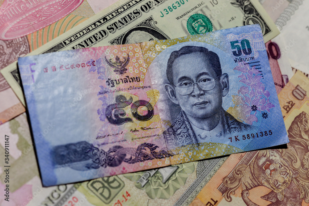 One US Dollar With Different Thailand Baht Banknotes Stock Photo one-us-dollar-is-enough-for-one-meal-youtube