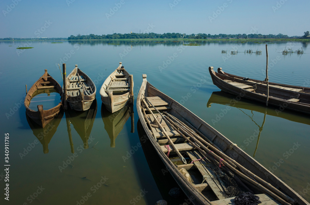 Wooden fishing boats on Taung Tha Man Lake at Amarapura, Mandalay, Myanmar Wooden fishing boats on Taung Tha Man Lake at Amarapura, Mandalay, Myanmar