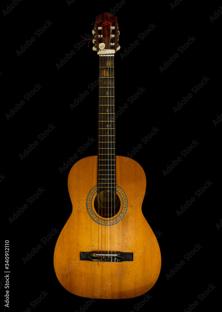 Guitar with six strings on black background