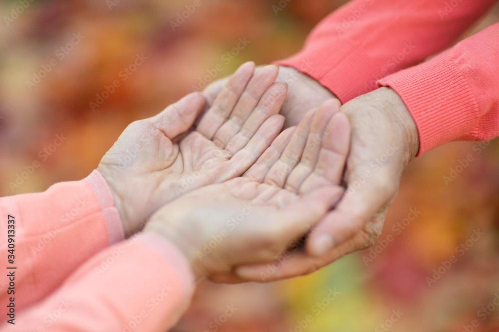 Couple holding hands together on the background Couple holding hands together on the background