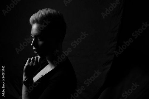 Girl with modern short hairstyle, studio portrait.