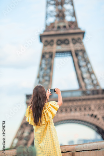 Beautiful woman in Paris background the Eiffel tower during her vacation © travnikovstudio