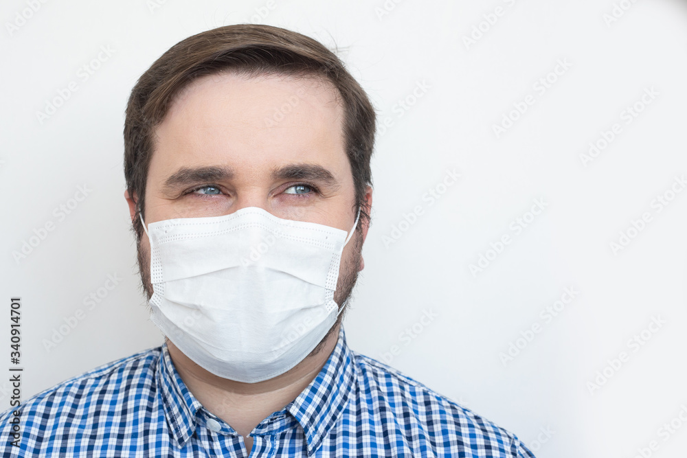 Man in medical mask on white background, copyspace, copyplace, space for text. Coronavirus, illness, infection, quarantine, medical mask Man in medical mask on white background, copyspace, copyplace, space for text. Coronavirus, illness, infection, quarantine, medical mask