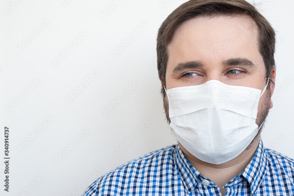 Man in a protective mask against coronavirus isolated on white. Coronavirus man mask, copyspace, copyplace, space for text. Coronavirus, illness, infection, quarantine, medical mask Man in a protective mask against coronavirus isolated on white. Coronavirus man mask, copyspace, copyplace, space for text. Coronavirus, illness, infection, quarantine, medical mask