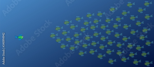 One fish against many other fish. One brave, opposing fish swims in the opposite direction to the school of fish - symbol for courage, individuality, diversity or being an outsider.

