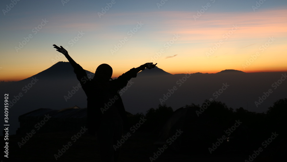 silhouette of a woman in the sunset at mount andong silhouette of a woman in the sunset at mount andong