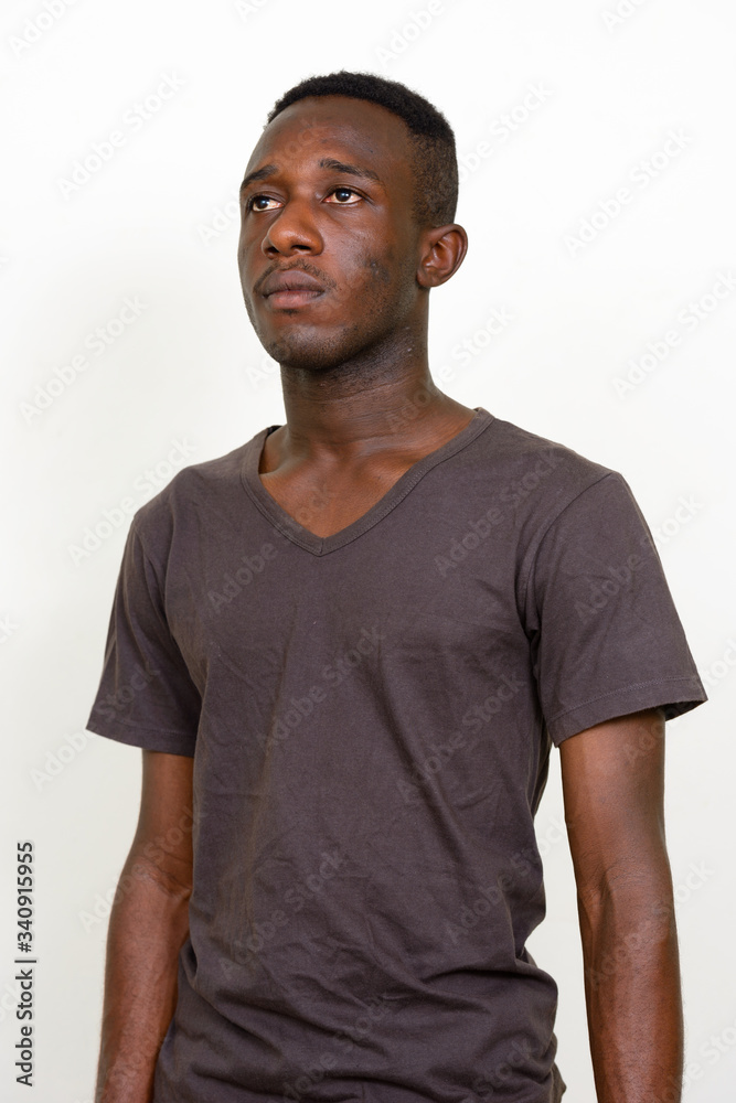 Portrait of young African man thinking and looking up Portrait of young African man thinking and looking up